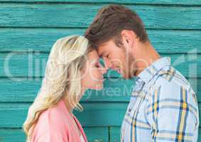 young happy couple with light blue wood background