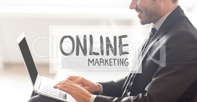 Online marketing text against businessman working on laptop