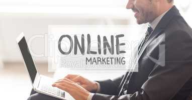 Online marketing text against businessman working on laptop