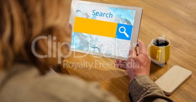 Cropped image of woman holding digital tablet with search text at table