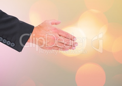 Hand reaching for handsake with sparkling light bokeh background