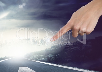 Hand touching sky with atmospheric road
