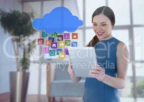 Businesswoman holding tablet with apps icons in office by window