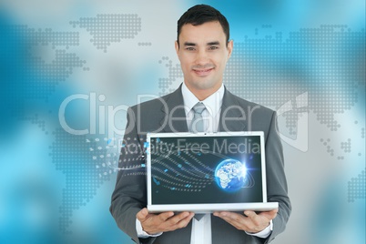 Businessman showing a laptop against world wide map background