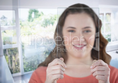 Woman holding glass screen by sunny window