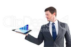Businessman holding a tablet with digital graphics