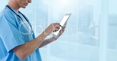 Doctor holding phone by blue city windows