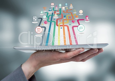 Hand holding tablet with apps with blur background