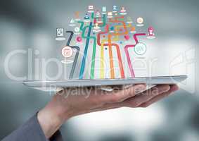 Hand holding tablet with apps with blur background
