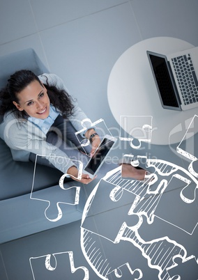 Overhead of business woman sitting with white jigsaw doodle