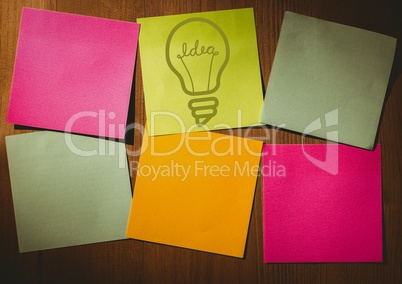 Green sticky note with lightbulb graphic and differently coloured blank notes