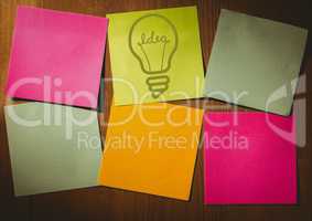 Green sticky note with lightbulb graphic and differently coloured blank notes