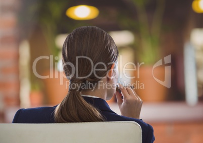 Businesswoman Back Sitting in Chair with cigar in cozy room