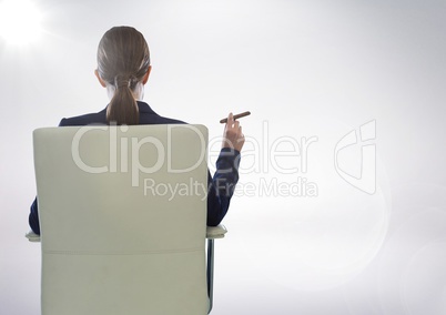 Back of seated business woman smoking cigar against white background with flare