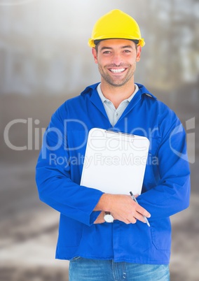 Construction Worker with pen chart in front of construction site