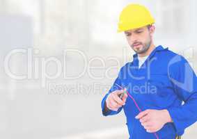 Electrician with wires cables on building site