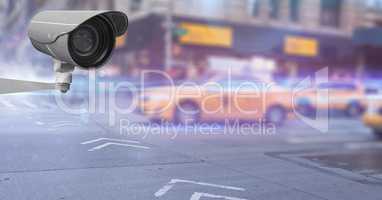 CCTV camera against cars moving on road in city