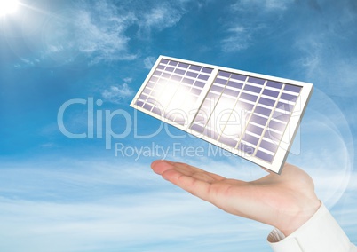Digital image of solar panel on hand against sky