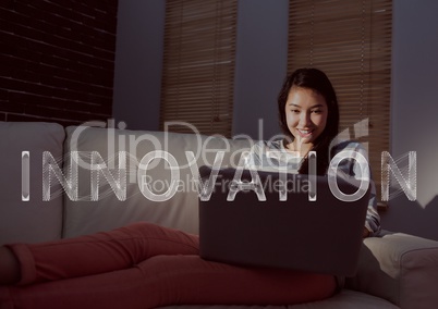 White innovation text and woman on couch with laptop