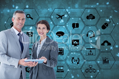 Businessman and businesswoman are holding a tablet computer against digital interface background