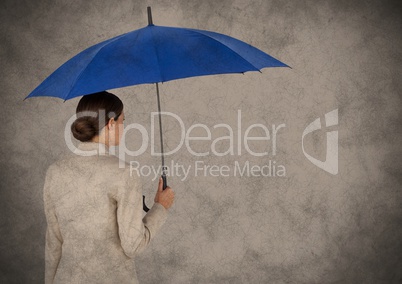 Back of business woman with umbrella against brown background and grunge overlay