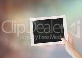 Hand with tablet with sparkling light bokeh background