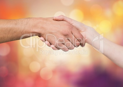 Hands shaking with sparkling light bokeh background