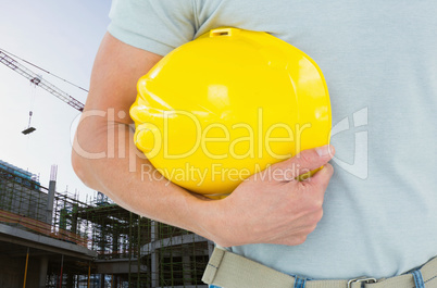 Worker holding his hard hat on the construction office