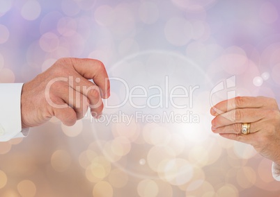 Old Couple Hands reaching with sparkling light bokeh background
