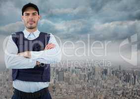 Security guard with arms folded against skyline and clouds