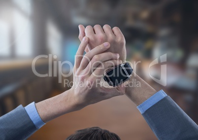 Businessman holding watch in large room