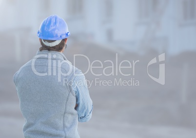 Construction Worker facing back in front of construction site