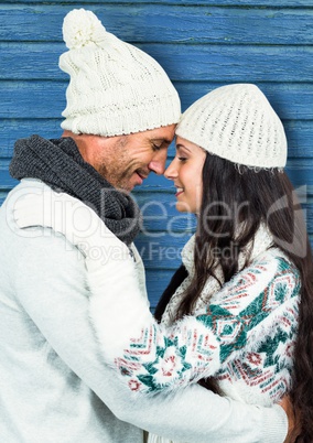 couple hugging with blue wood background