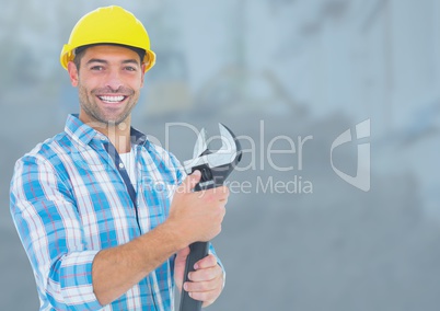 Construction Worker with wrench tool in front of construction site