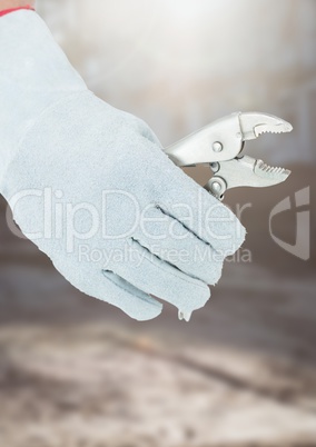 Hand with plier on building site