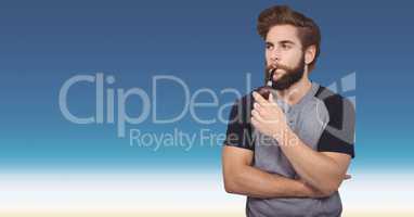 Hipster smoking pipe against blue background