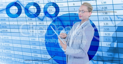 Businesswoman holding digital tablet standing by numerical background