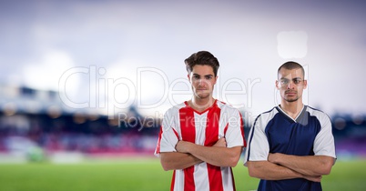 soccer players with his hands folded, blurred field background