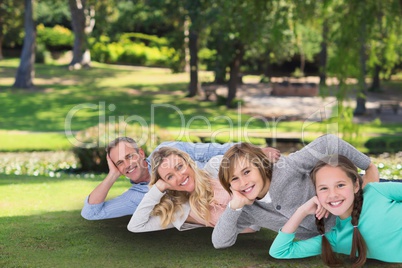 Happy family laying on the grass