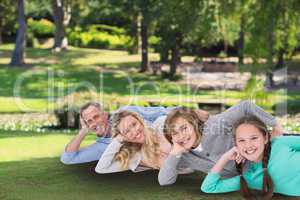 Happy family laying on the grass