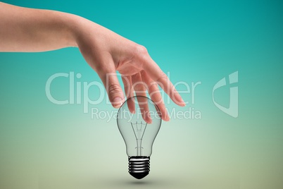 Hand holding bulb light in green background