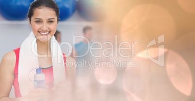 Woman with bottle and towel and peach bokeh transition