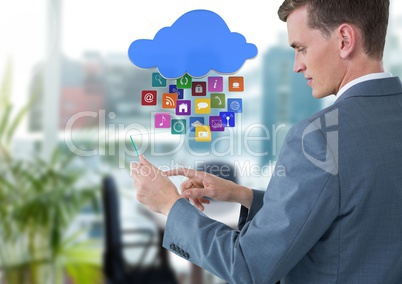 Businessman holding glass tablet with apps icons in bright office