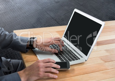 Businessman using laptop on desk