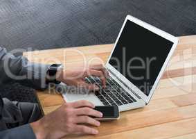 Businessman using laptop on desk