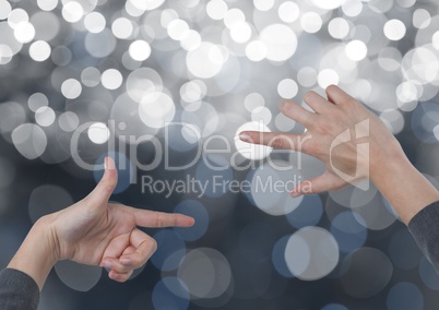 Hands  creating rectangle invisible shape with sparkling light bokeh background