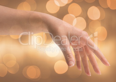 Hand reaching kindly with sparkling light bokeh background