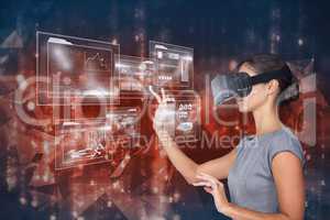 businesswoman wearing virtual reality headset is touching graphics against abstract background