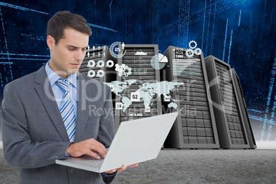Businessman holding a laptop in a data center