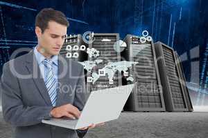 Businessman holding a laptop in a data center